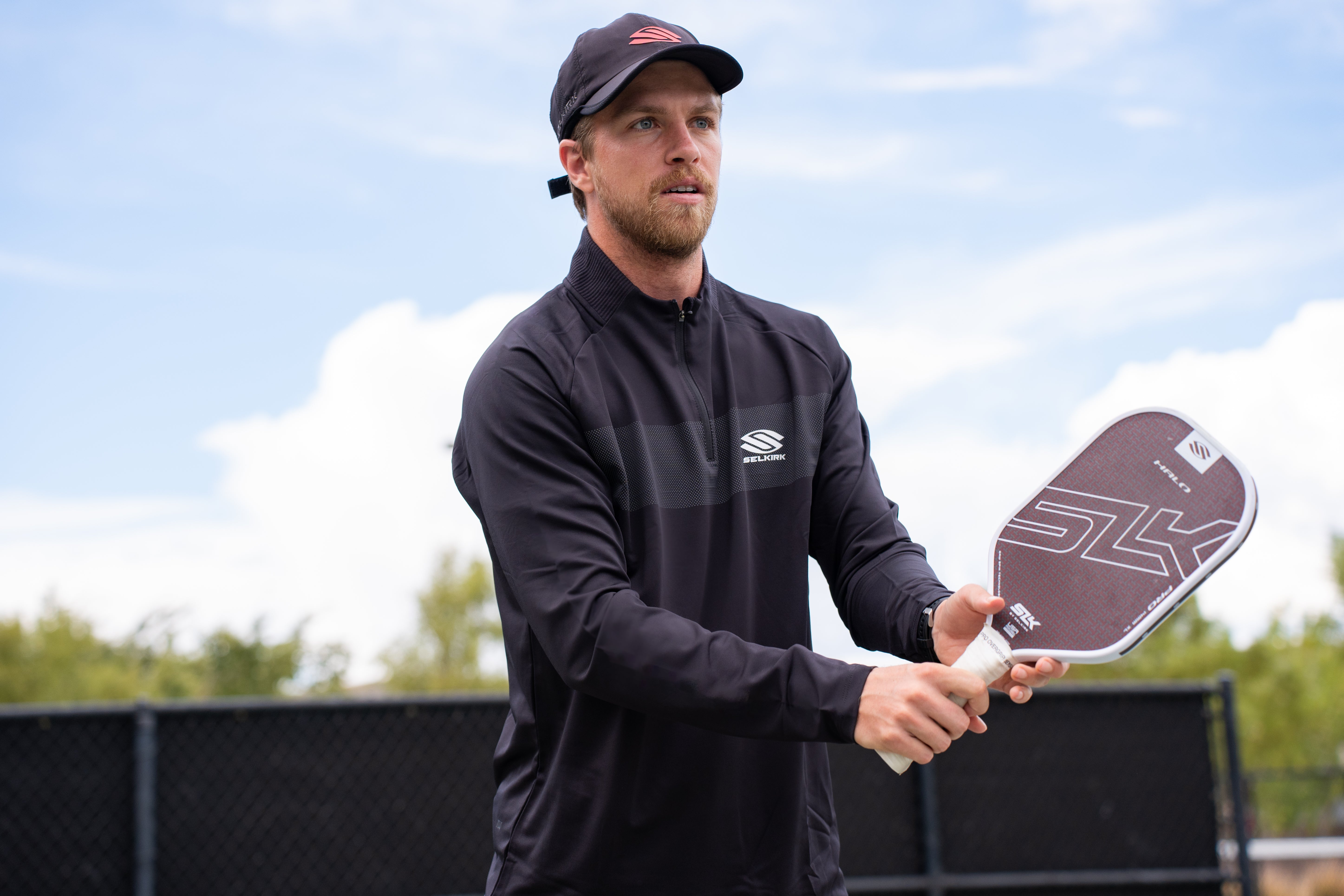 A man prepares for for a volley shot with his SLK Pro Halo. 