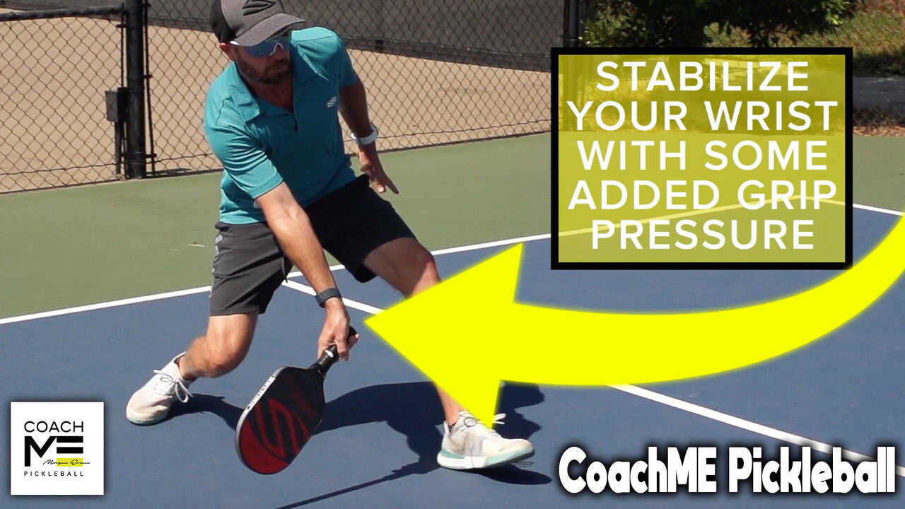 Morgan Evans plays on an outdoor pickleball court. He maintains a low, defensive position as he retrieves a hard-hit ball. 