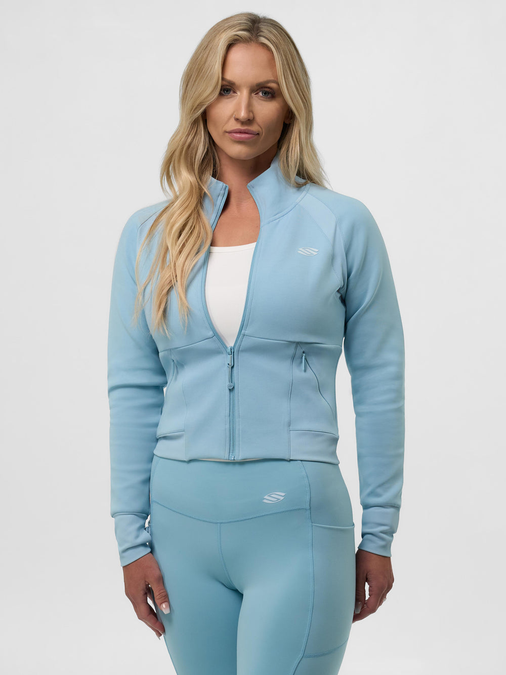 Selkirk pickleball women's cropped jacket in black, white, and blue.